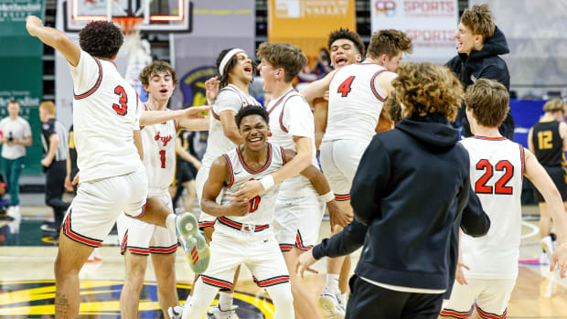 Judah Harris (0) and the Jefferson City boys basketball team celebrate their Missouri Class 5 semifinal win over Vianney